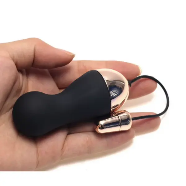 black egg vibrator held by a hand to show it's size