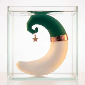 MoonSway moon shaped sucker and vibrating dildo submerged in water, showcasing waterproof design with curved crescent shape and star charm detail