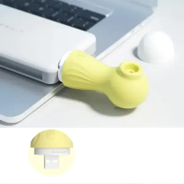 yellow mini seahorse sucking vibrator connected to a laptop and showing usb charger init
