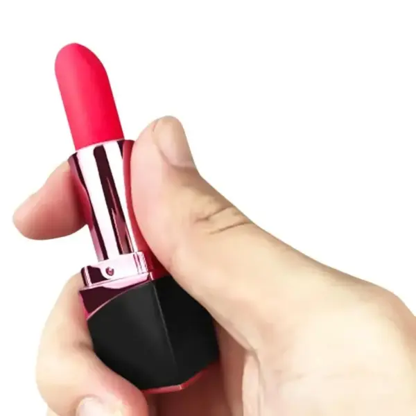 A hand is holding a discreet, lipstick-shaped vibrator with a pink silicone tip, shiny rose gold middle, and black base. The compact size fits easily in the palm, highlighting its portable and incognito design.