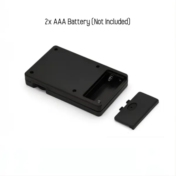 Battery compartment of the remote control for electric nipple clamps, labeled for two AAA batteries (not included).
