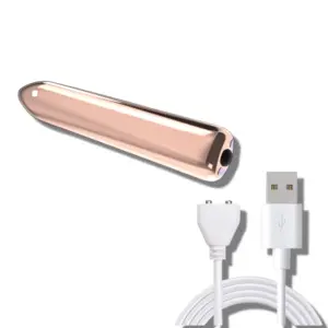 A sleek gold mini vibrating bullet shown with its white magnetic USB charging cable, highlighting its compact and discreet design.