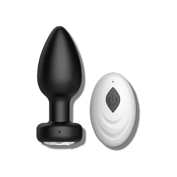 A black remote controlled butt plug paired with a white wireless remote featuring a power button, designed for hands-free control and enhanced pleasure.