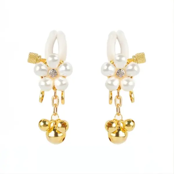 Close-up of the floral pearl nipple clamps with gold detailing and bell charms.
