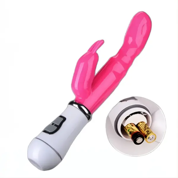 Pink Battery Powered Rabbit Vibrator – Deep Bliss lying on its side with its base removed, revealing two AAA batteries inside the compartment alongside a circular close-up insert of the open battery slot.