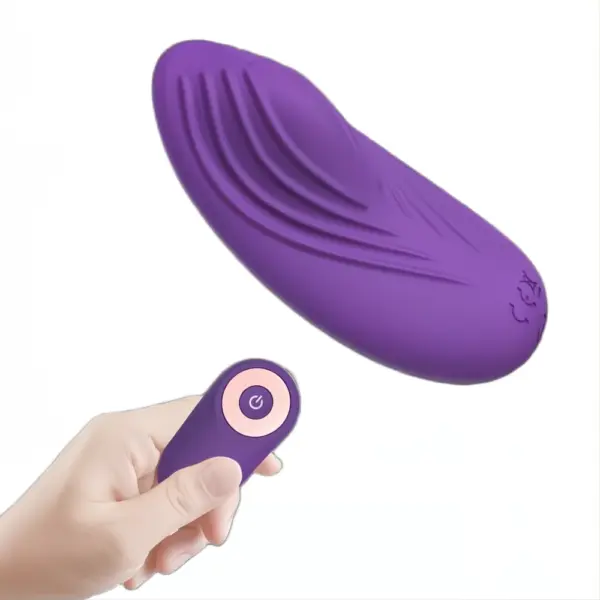 Hand holding the remote control while the curved Secret Purr vibrator hovers above, highlighting its ergonomic design for discreet wearable pleasure.