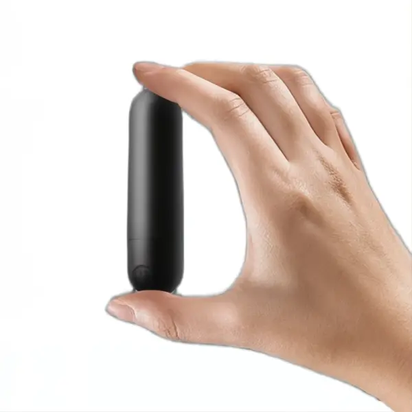 A hand holding a compact black silicone rechargeable bullet vibrator vertically between two fingers, emphasizing its discreet size.