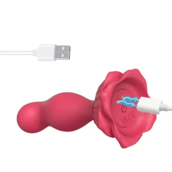 APP Control Butt Plug Vibrator Starpetal side view with USB charging cable plugged into the magnetic DC port at the base
