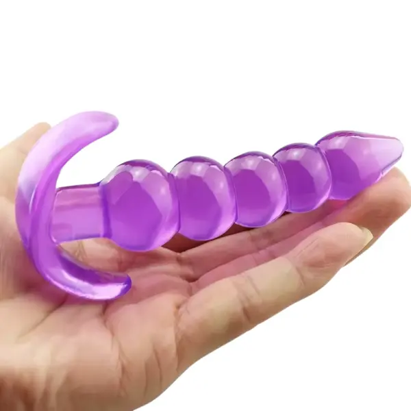 Hand holding the purple five-bead silicone butt plug, highlighting its smooth graduated beads and ergonomic T-shaped base.