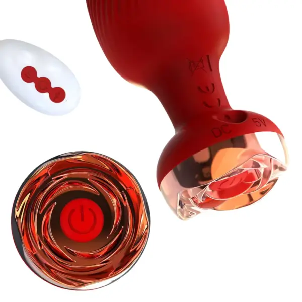 Remote Control Vibrating Butt Plug – The Murmur close-up of the rose-gold swirl base control button on the red silicone plug