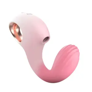 Angled view of the Dolphin Suction G-Vibes-Curve Appeal in soft blush pink, showcasing its dolphin-style silicone suction nozzle on the upper arm and ribbed G-spot stimulator on the curved lower arm. The white ergonomic handle features a rose-gold finger-loop for secure grip during hands-free play.