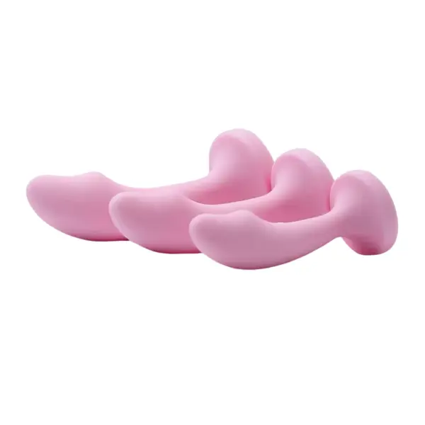 Side profile of the Pink Curved Butt Plug-Cherry Velvet lineup shows small, medium, and large plugs resting horizontally. The shot highlights their ergonomic curve, rounded tip, and flat, suction-style base design for stable, comfortable wear.