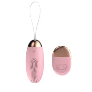 The Velvet Pop Remote Control Rugged Egg Vibrator in soft pink with gold-toned accents, featuring a textured silicone body and matching wireless remote control.