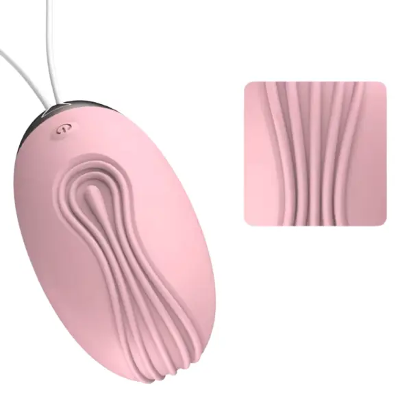 Close-up of the Velvet Pop Remote Control Rugged Egg Vibrator’s ridged texture in pink, highlighting its contoured silicone surface for intensified stimulation.