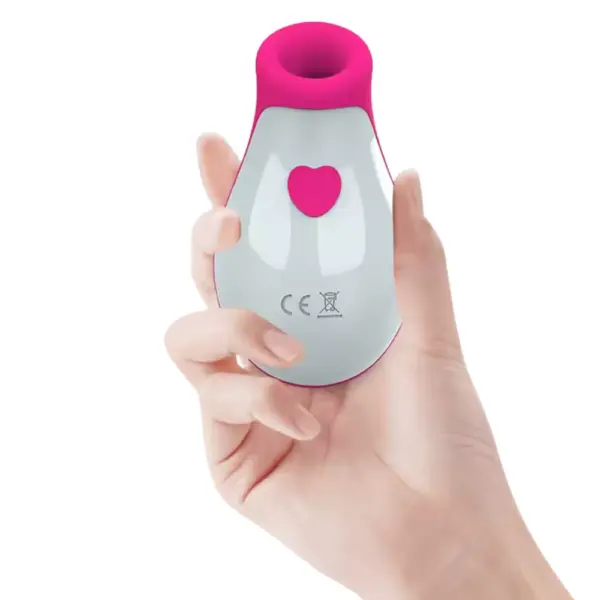 A hand gently holding the Honeydrop suction vibrator to illustrate its compact, ergonomic shape and easy-access heart-button control.