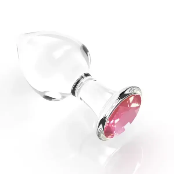 Angled view of the Crystal Clear Butt Plug – Clear Love, showing its clear glass body and faceted pink gem at the base against a white background.