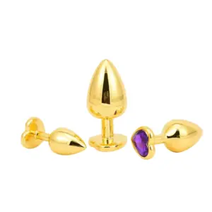 Butt Plugs With Jewel – Glitzie in various positions displaying tapered gold shapes and one plug featuring a deep purple heart-shaped jewel.