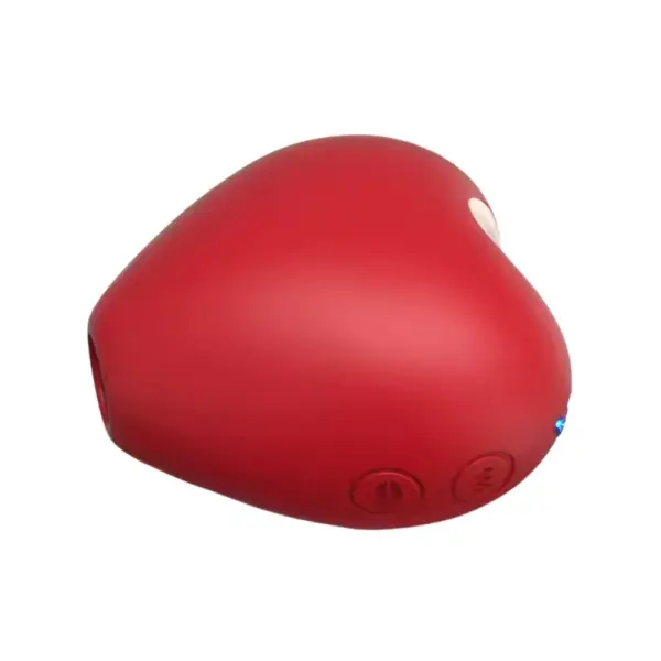 Red heart-shaped rechargeable suction vibrator angled to reveal its power and mode buttons on the side, set against a white background.