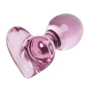 Glass heart shaped butt plug Love Vice close-up on the heart-shaped base and polished glass surface