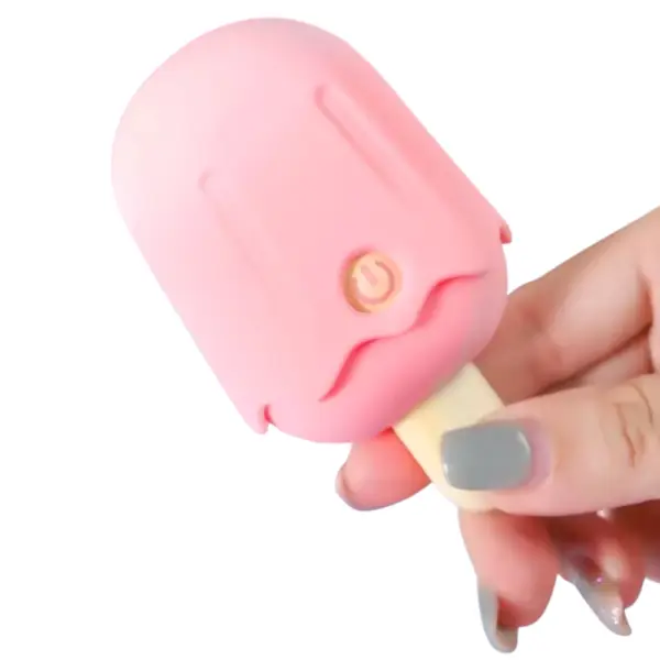 Lustful Treat’s Mini Popsicle Suction Vibrator held between fingers, highlighting its compact popsicle design and playful pastel finish.