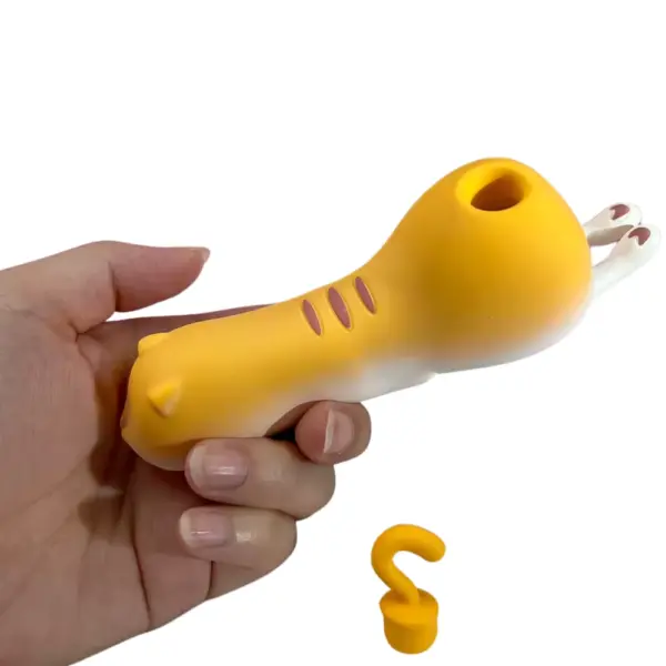 Yellow Kitty Suction Vibrator – side view of the Sexy Purr ergonomic kitty body gripped in hand with suction opening visible