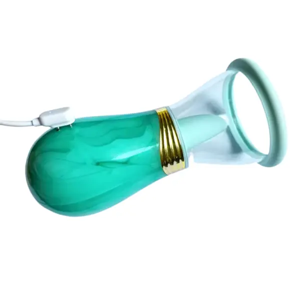 Mint Luscious Lick licking and sucking vibrator connected to its magnetic charger plug
