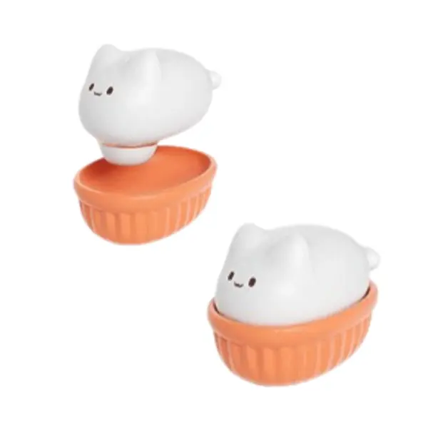 Two Kitty Swirl units side by side—one with the white cat head lifted off its orange base to show the removable design, the other fully assembled.