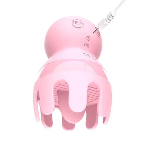 Close-up of the pink Licker and Sucker Vibrator - Octopussy with a charging cable plugged into the DC port at the back of the toy.
