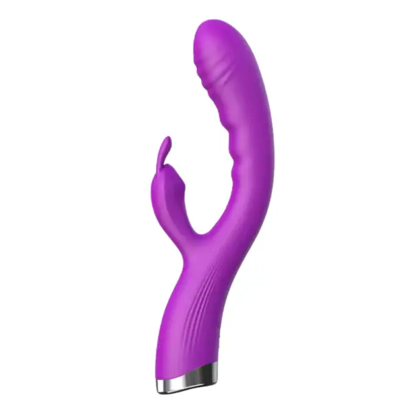 Angled view of the purple Flutter Flick vibrator displaying its smooth silicone curve, ribbed shaft, and compact rabbit-style clitoral stimulator arm.