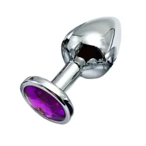 Close-up angle view of a metallic silver butt plug with an oval purple faceted gem embedded in its flared base, set against a white background.