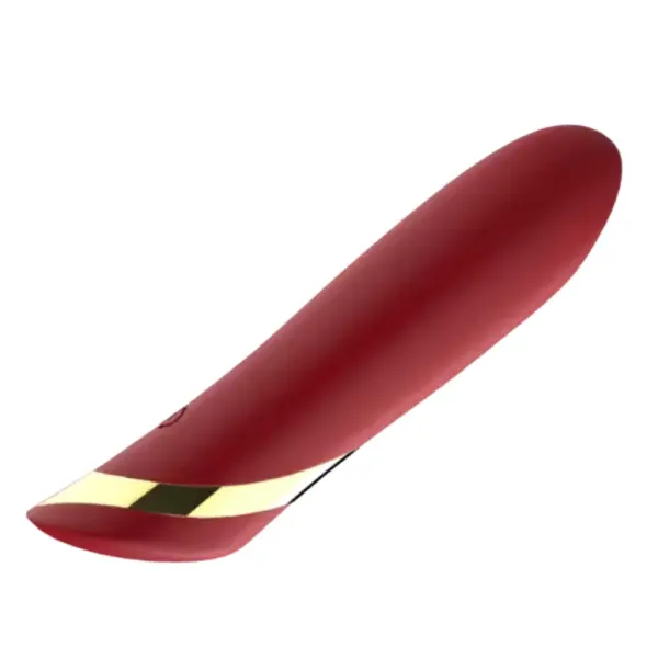 Angled side view of the Cheeky Charm rechargeable bullet vibrator in red, highlighting its slender, gently curved tip, seamless silicone finish, and metallic gold accent.