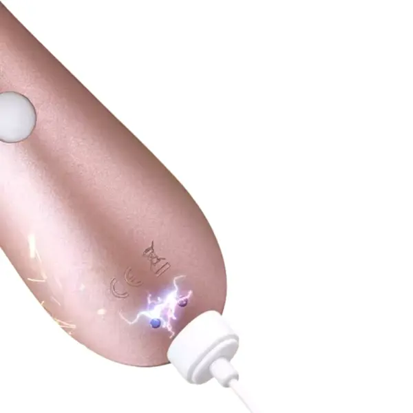 Detailed shot of the Satisfyer Pro 2+ Clit Sucker’s base snapped to its white USB magnetic charging puck, with subtle electric spark graphics emphasizing the secure recharge. The smooth metal contacts and seamless silicone finish underscore the toy’s convenient, cordless charging capability.