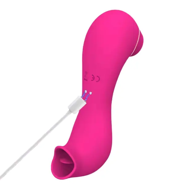Pink Double Trouble vibrator connected via its magnetic USB charging cable to the two metal charging pins on the back of the device.