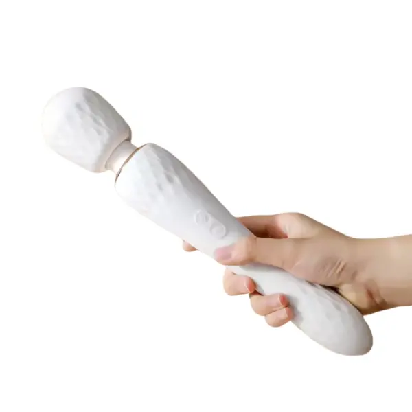 A hand holding the Opal Kiss vibrator horizontally to illustrate its ergonomic length, textured head and tail, and easy-reach control buttons.