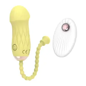 The Remote Control Love Egg-Luxe Pebble in soft lemon yellow sits next to its matching white remote control. Its ergonomic silicone shell and textured retrieval tail highlight user-friendly design and seamless remote operation.