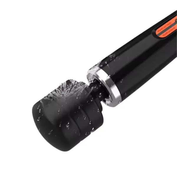 Close-up of the Powrette vibrator’s black head covered in water droplets, highlighting its waterproof silicone design and durable neck joint.