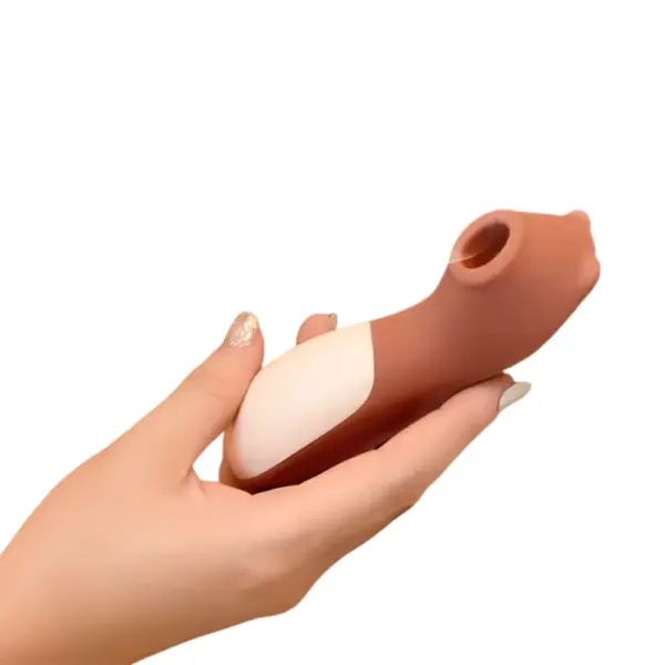 Clit Suction Vibrator – Cubby being held in hand, showing its compact size and contoured shape designed for comfortable use.