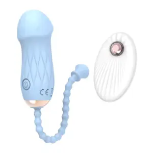 The sky blue Remote Control Love Egg-Luxe Pebble is shown alongside its coordinating white remote control. This smooth, pebble-shaped vibrator with a flexible beaded cord demonstrates both comfort and convenient wireless control.