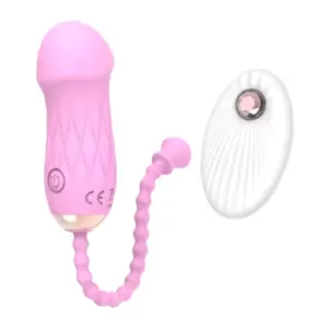 Close-up of the Remote Control Love Egg-Luxe Pebble in blush pink paired with its white wireless controller. This pebble-shaped pleasure egg features a ridged retrieval cord and intuitive one-button interface for discreet, customizable vibration.