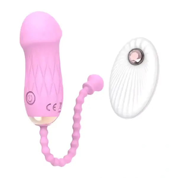 Close-up of the Remote Control Love Egg-Luxe Pebble in blush pink paired with its white wireless controller. This pebble-shaped pleasure egg features a ridged retrieval cord and intuitive one-button interface for discreet, customizable vibration.