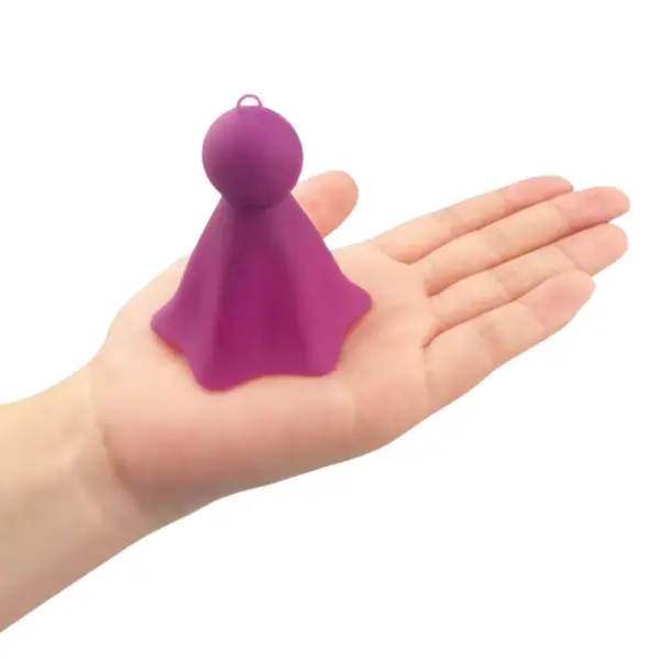 The Single Nipple Stimulator-Boobie Boo resting on an open palm, showing its compact size and lightweight, flexible form.