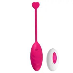 Quiet Egg Vibrator – MuteMuse in vibrant pink featuring a ribbed silicone body, heart-shaped tail, and a white remote with matching controls.