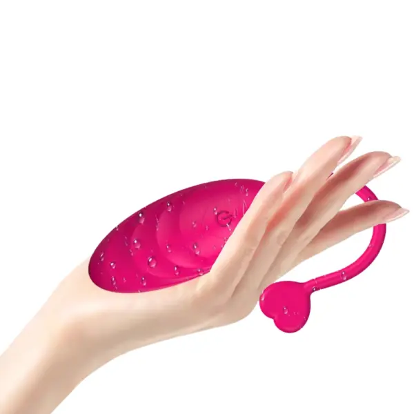 Quiet Egg Vibrator – MuteMuse displayed in an open palm with water droplets on the pink silicone surface, highlighting its waterproof design and soft-touch finish.