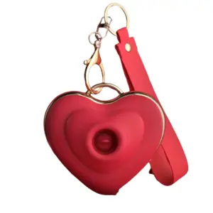 Close-up front view of the Keychain Licking and Suction Vibrator - Heart Flutters in bold red, shaped like a heart with gold trim and attached strap, showcasing the suction nozzle in the center.