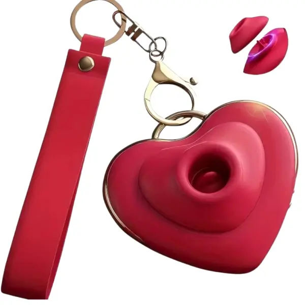 Red Heart Flutters keychain vibrator shown with attached red strap and open top view, highlighting the heart-shaped design, nozzle depth, and included protective lip-shaped cover accessory.