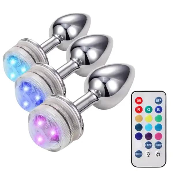 Three LED Light Butt Plug – Booty Glow devices glowing in soft blue and purple hues, shown with a matching remote for color customization.