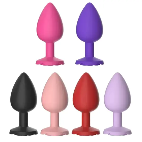 Small Butt Plug – TinyTush shown in six colors including pink, purple, black, blush, red, and lavender, each with a soft silicone build and flared rose-style base.