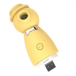 Yellow variation of the USB Rechargeable Suction Vibrator TopHat with exposed USB plug for direct charging, designed with a mini top hat and bowtie.