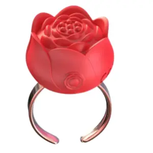 Close-up of the Bloomé Discreet Clitoral Stimulator Ring in vibrant red, designed like a blooming rose with a sleek adjustable band.