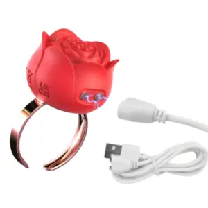 Side view of the red Bloomé Discreet Clitoral Stimulator Ring showing dual stimulation points with blue electric pulses and a USB charging cable included.